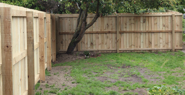 wooden fence frame with posts set in concrete