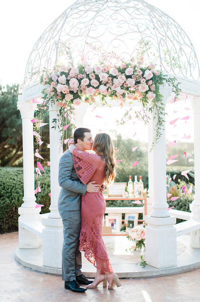 couple kissing in front of gazebo