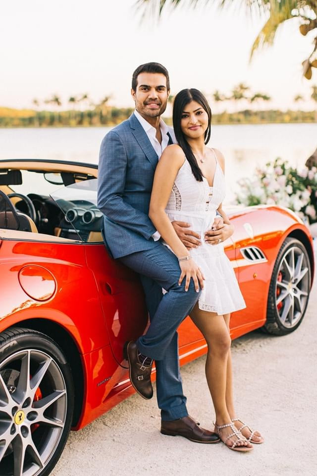 engagement photo with sock that hides ring box and red car