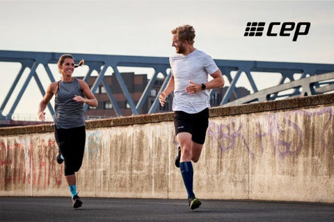 Two people running wearing compression socks