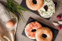 tray of sliced bagels with cream cheese lox and chives