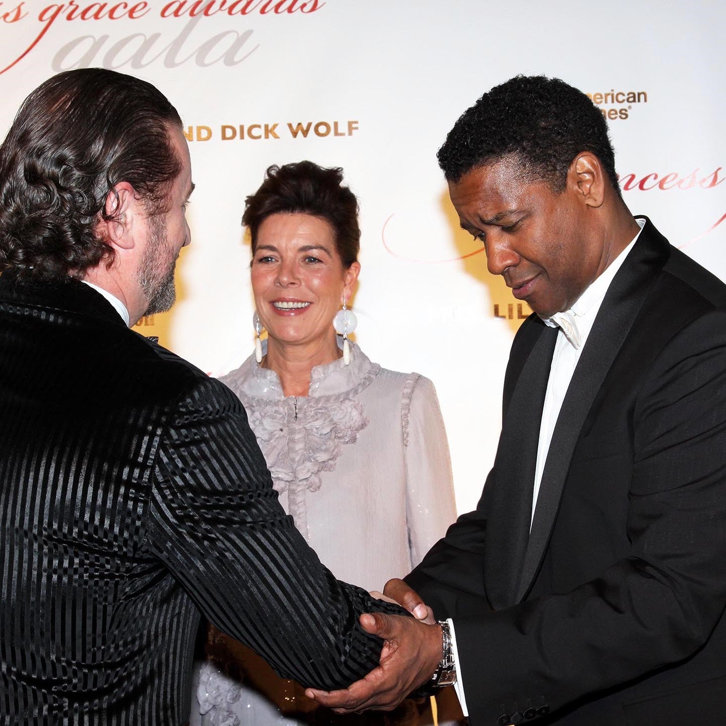 Alex Soldier and Princess Caroline of Hanover present Denzel Washington with the Princess Grace Award, designed and created by Alex Soldier.