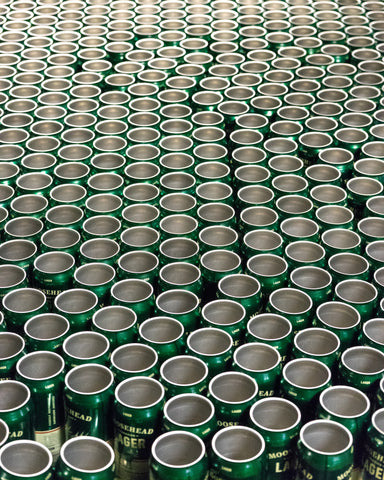Untopped Moosehead cans roll down a conveyor belt in the Saint John Factory. 