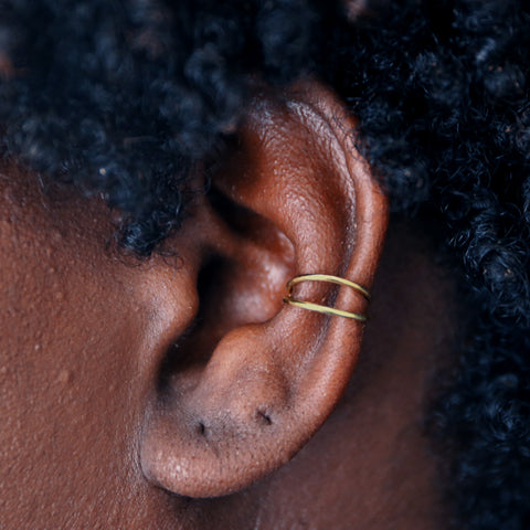 person's ear wearing a cuff
