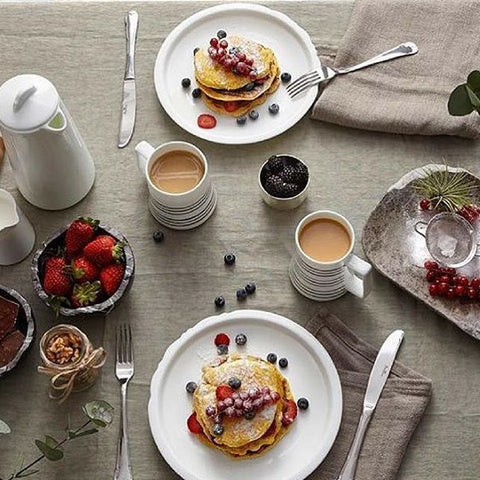 Coffee cups with pancakes