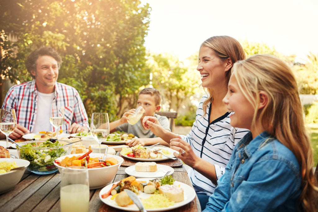 People eating outdoors at a table