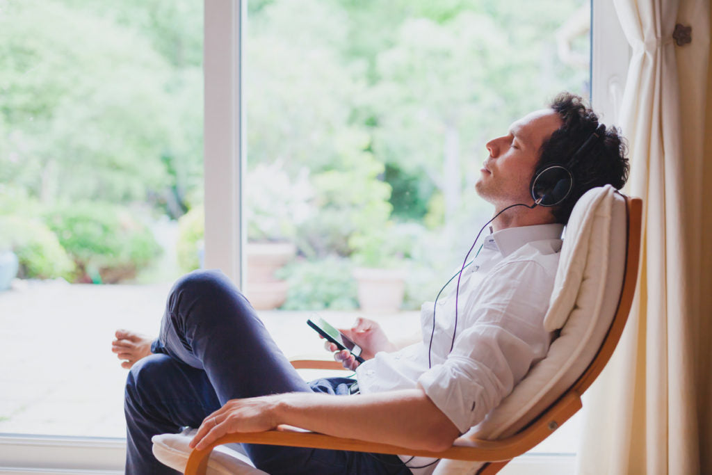 Relaxing in a chair listening to calm music with eyes closed | HealthMasters