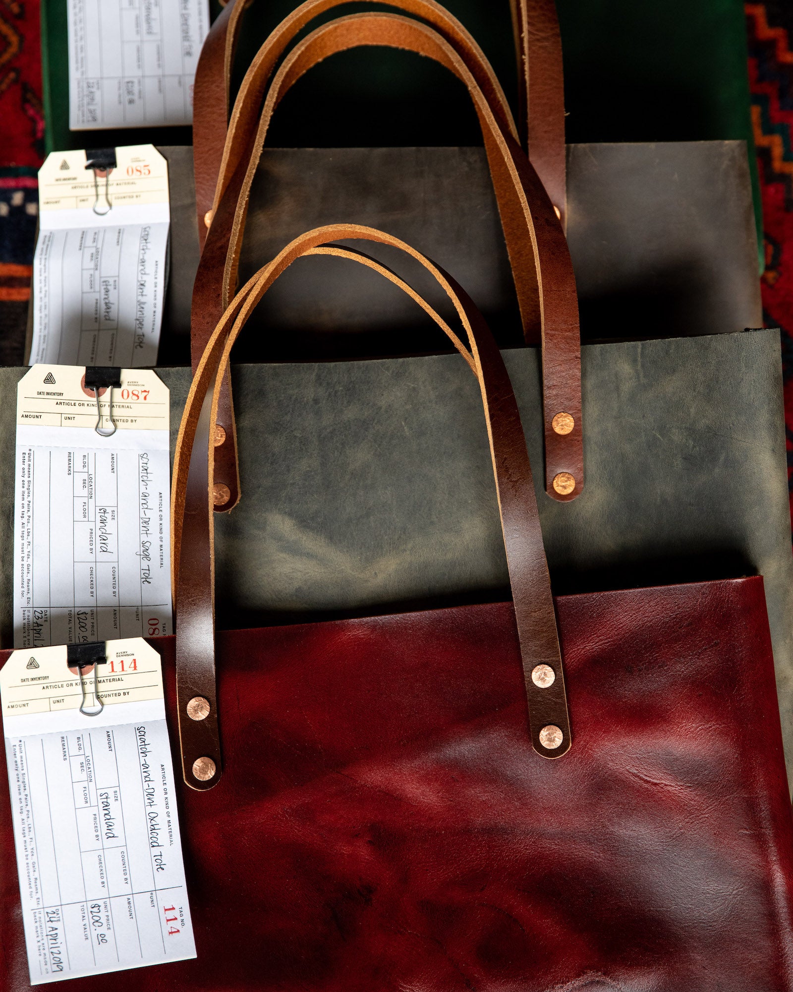 Scratch-and-dent leather tote bags