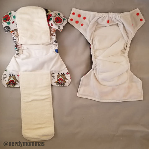 flat lay photo of two "All-in-one" diapers. (left) Flap AIO (Right) sewn-in insert AIO