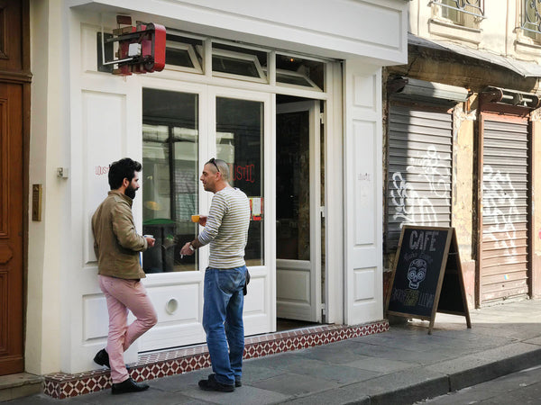 Men chatting outside Café Loustic in Paris