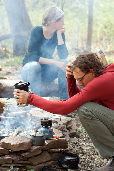 Trevor drinks Homestead coffee by campfire