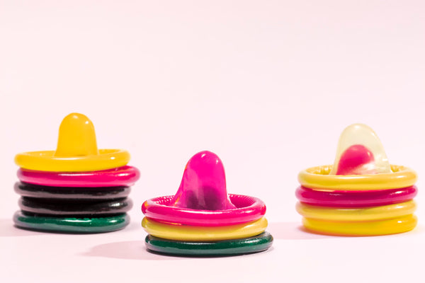 colorful-condoms-in-pink-background