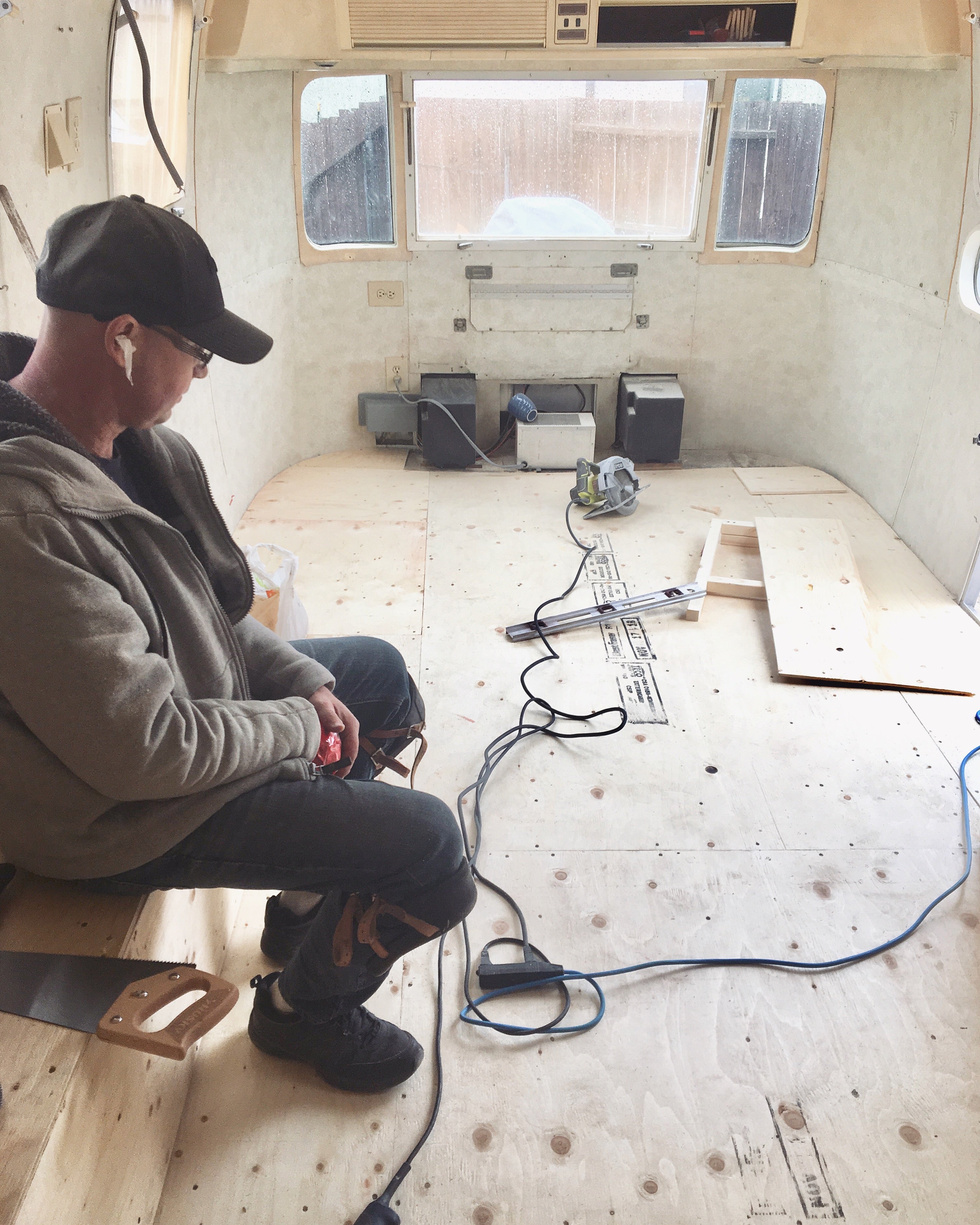 Robert is sitting in an Airstream trailer, admiring his work for the day as he transforms it into Edmonton's first Airstream Boutique.