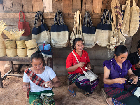 khmu women working outside of their homes in northern Laos 