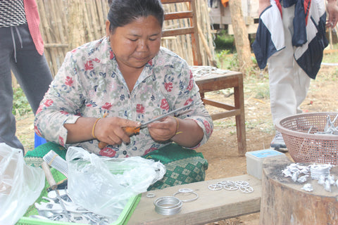 artisan in Laos making handicrafts from war sharpnel 