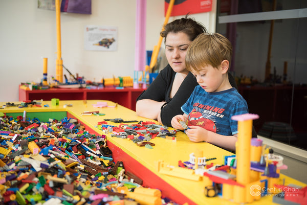 Mother and child engaging and playing at LEGO table