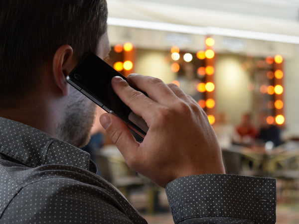 Man talking on the phone monitoring lost baggage