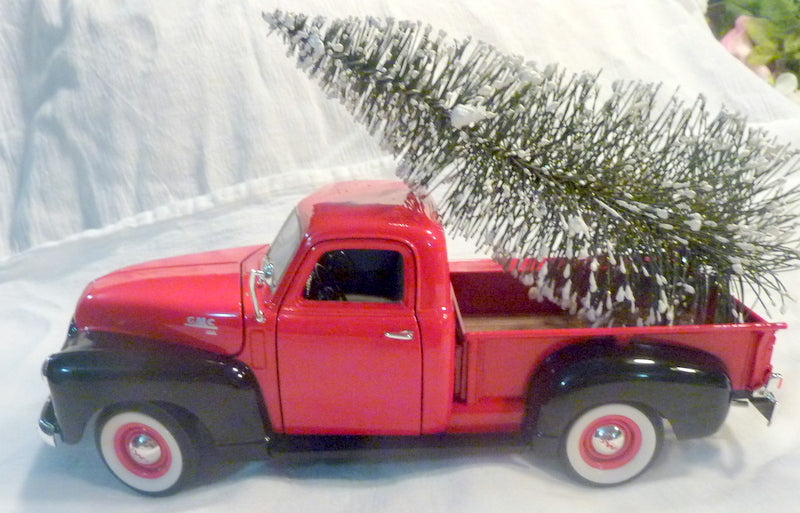 toy red truck with christmas tree