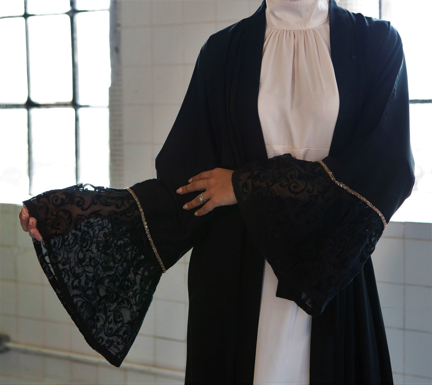 Aaliya Collections Black Bell Sleeve Abaya with contrasting lace sleeves bordered with striking gold sequin trimming