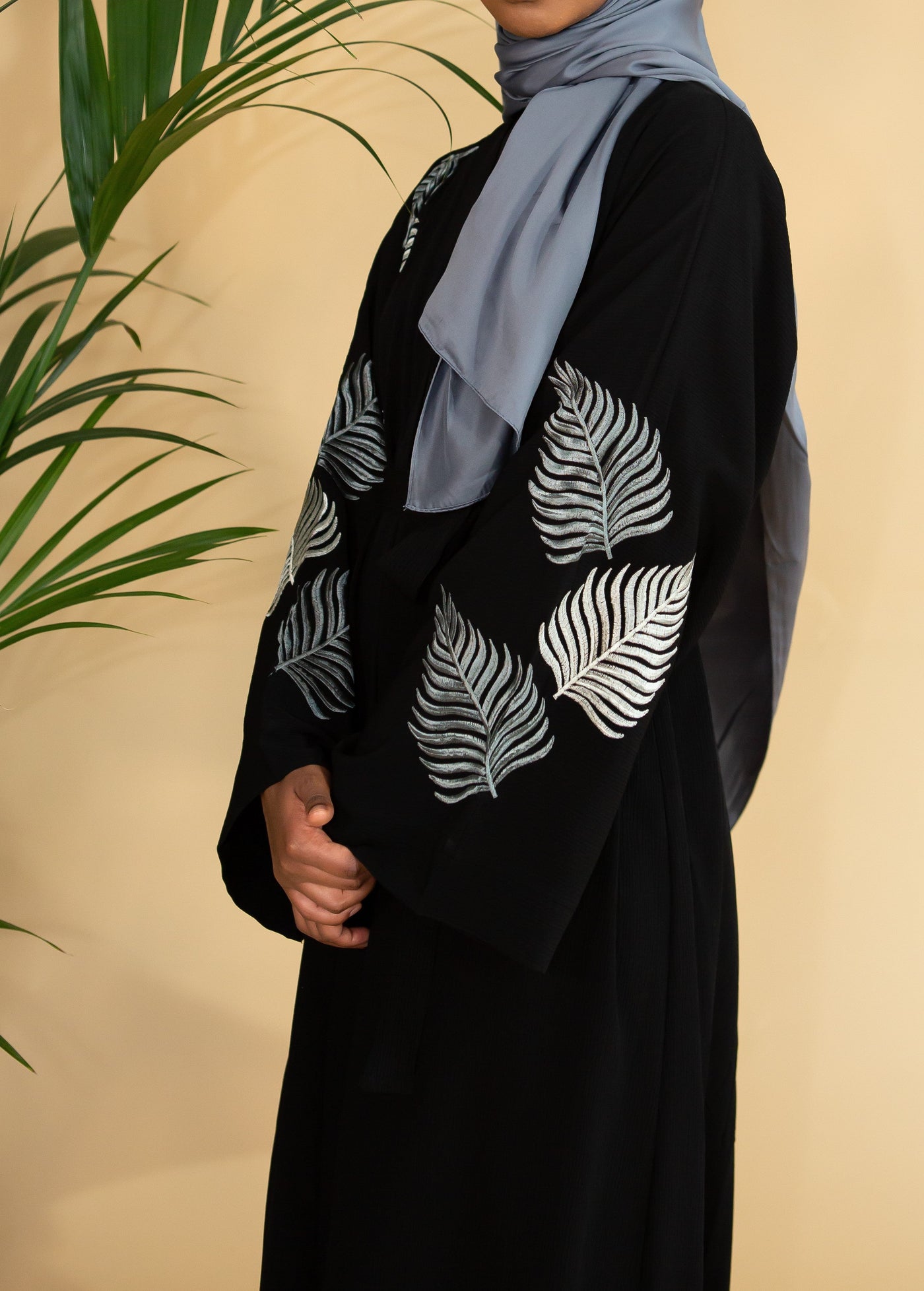 Aaliya Collections Grey Leaf Abaya Created with contrast in mind, a stunning black abaya with gorgeous grey shades in leaf embroidery