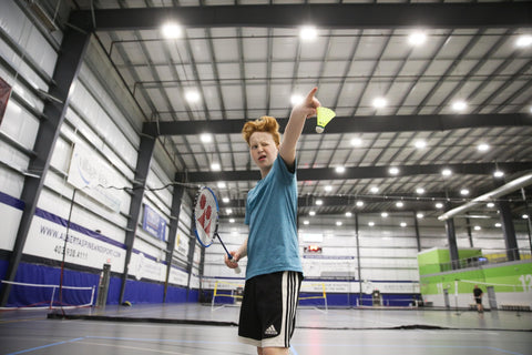 Red Head Young Boy Playing Badminton Pointing Racket Finger