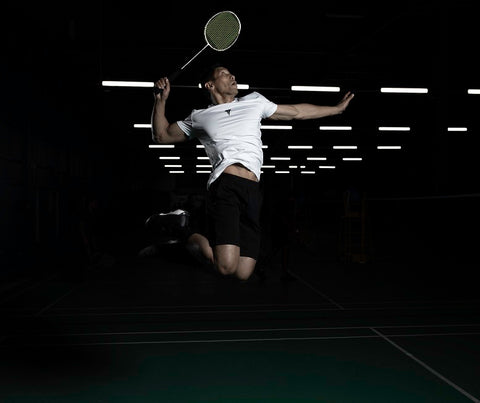 Man jump smash badminton shuttle racket