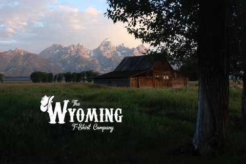 The Wyoming T-Shirt Company barn in front of mountains