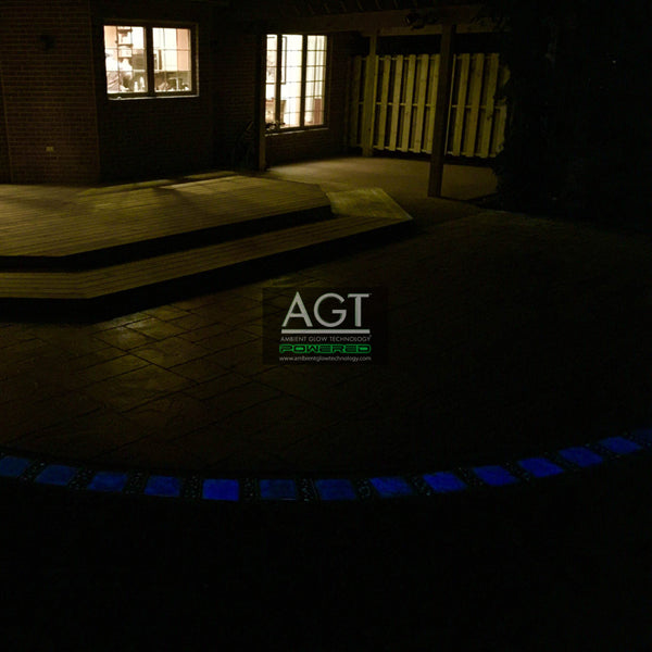 Night time view of glowing patio stones powered by AGT™ Sky Blue Fine Glow Sand.