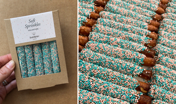 Chocolate covered pretzels with teal blue and blush pink sprinkle colors for Baby Bjorn