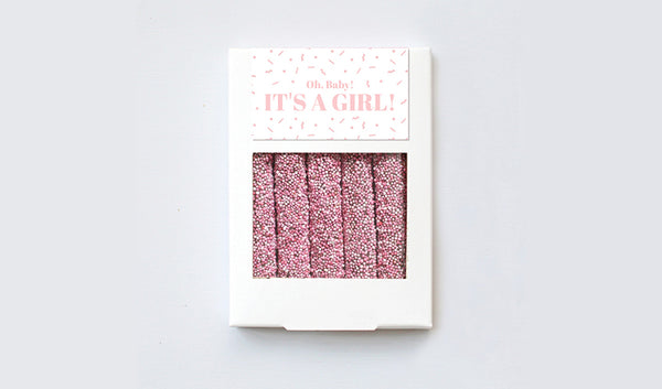 White box of five pretzels with baby pink sprinkles and baby girl customized design