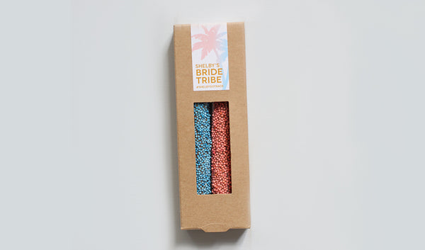 Kraft box of two pretzels with coral and teal sprinkles and customized bachelorette design