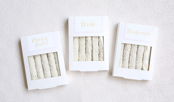 Bride, bridesmaid, and maid of honor white boxes with five white sprinkles pretzels each