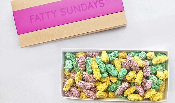 Easter gift box filled with chopped chocolate covered pretzels topped with pastel colored sprinkles