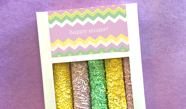 White box of five pretzels with pastel colored sprinkles and customized Easter design