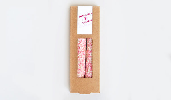Kraft box of two pretzels with light pink and white sprinkles and customized birthday design