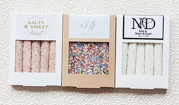 Boxes of five chocolate covered pretzels each with customized wedding design