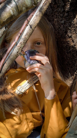 Girl wearing children's waterproof jacket in Acorn