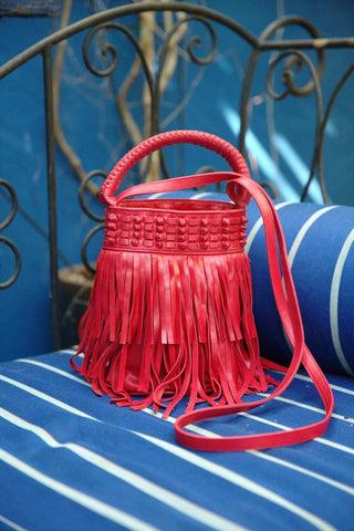 Bright red crossbody bucket bag with fringe detailing makes a great Valentine’s Day accessory