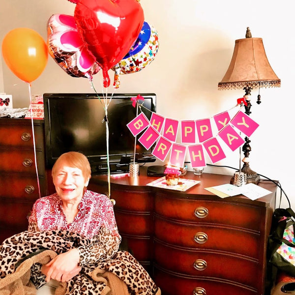 Senior citizen woman celebrating a milestone birthday with Birthday Butler