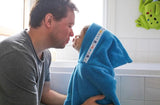 Bathtime snuggles in a hooded towel with daddy
