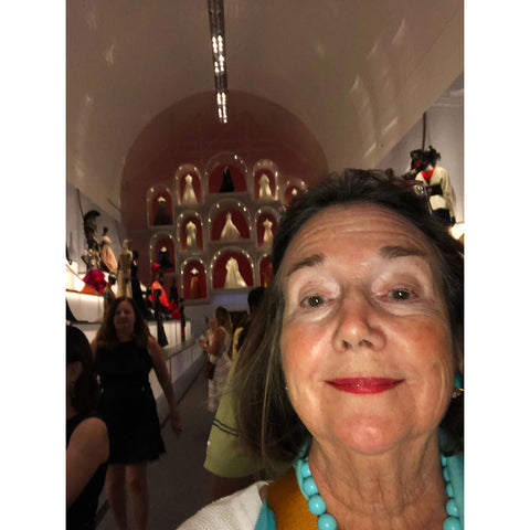 Mary is taking a selfie at the Dior exhibit in Dallas