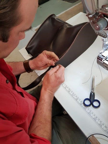Angus hand stitching the corners of the Giovanni Tote Bags for added strength.