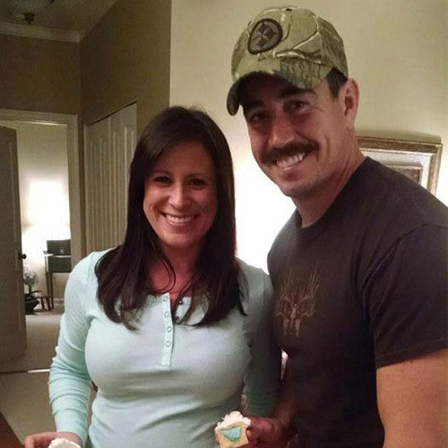 Military mom and dad revealing sex of baby with cupcake