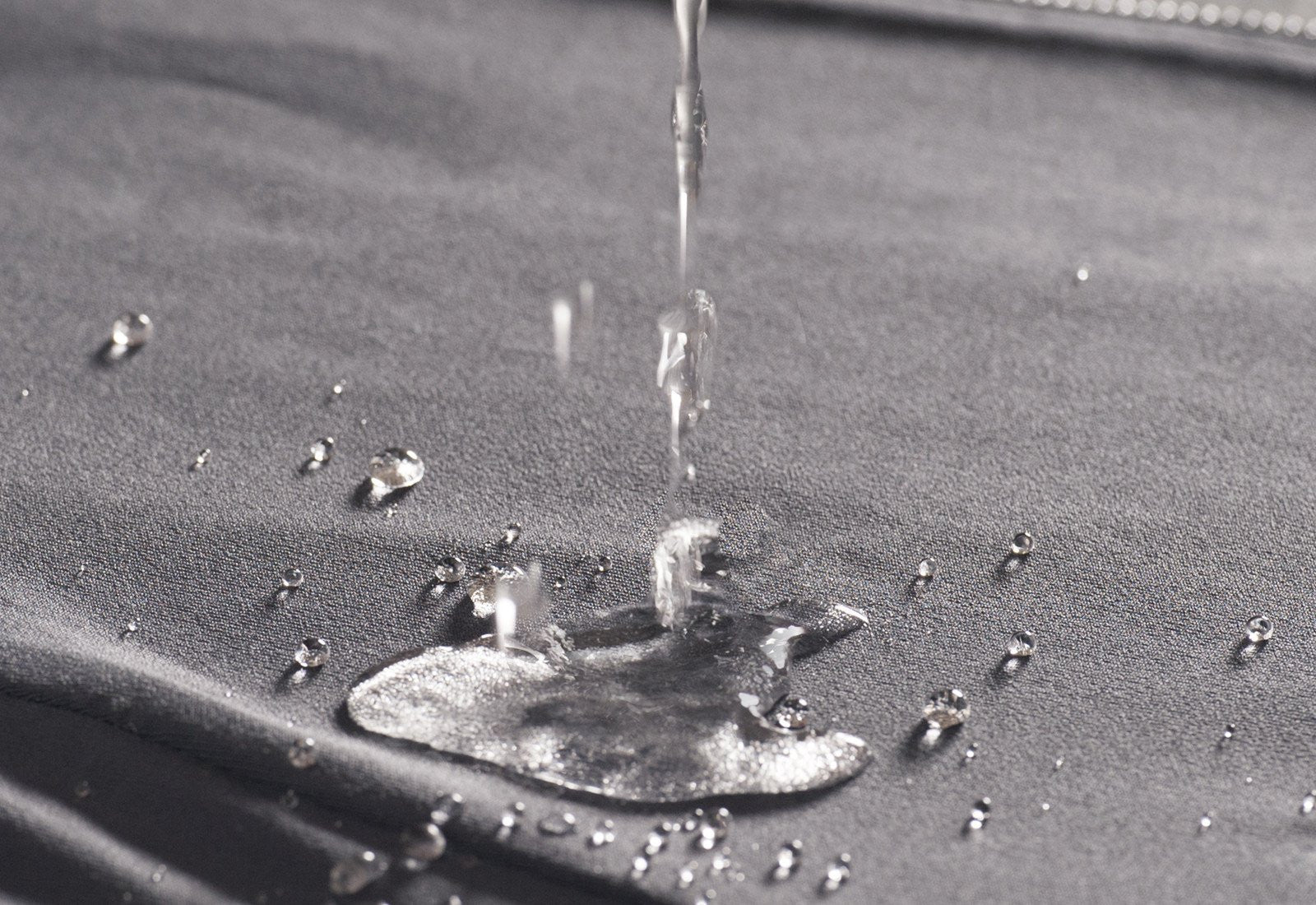 Water droplets beading up on the surface of Chefletics fabric