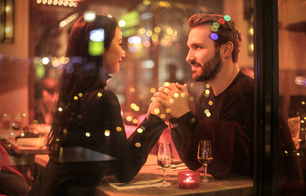 Couple in a restaurant smiling at each other