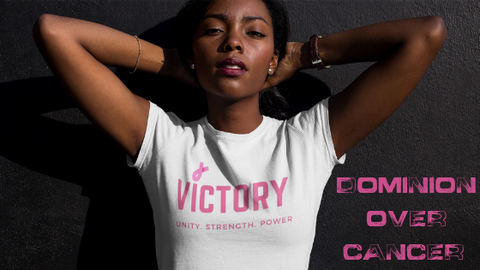 Black woman with white Breast Cancer Awareness shirt that reads Victory, unity, strength, power printed in pink color letters and pink breast cancer awareness ribbon 