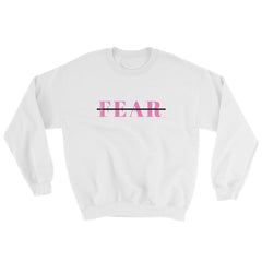 White color long sleeve unisex sweatshirt with words fear printed on front in pink crossed out with black line and scripture verse printed in logo