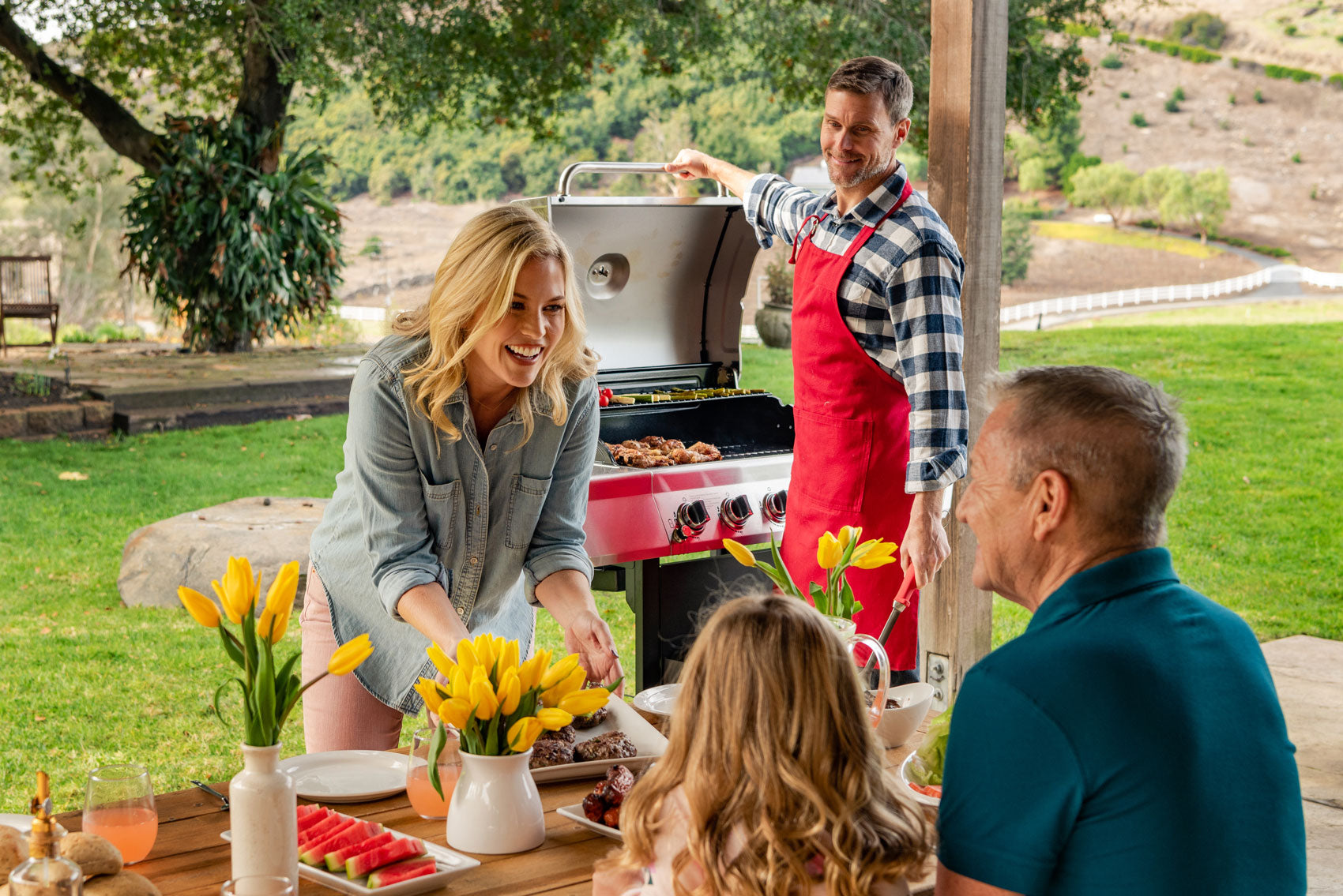 Family grilling in the backyard on the Nexgrill 5-burner gas grill
