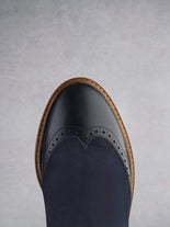 Featuring traditional brogue detailing over a round toe shape.