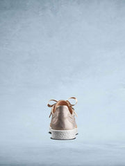 This stylish rose gold trainer has a contrasting textured white sole.